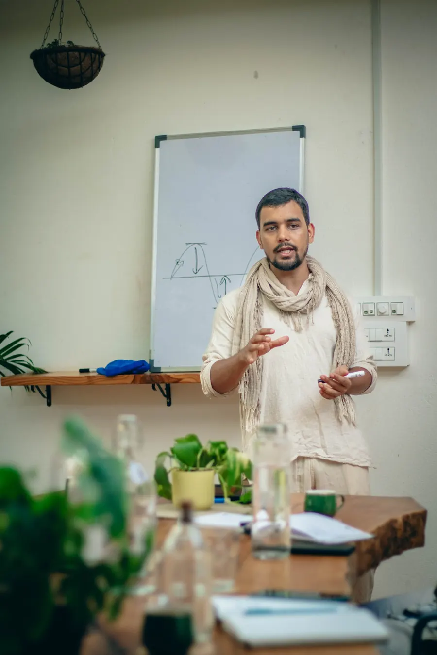 Himanshu Bisht explaining a wave diagram on a whiteboard during a workshop