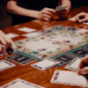 People playing a board game around a wooden table